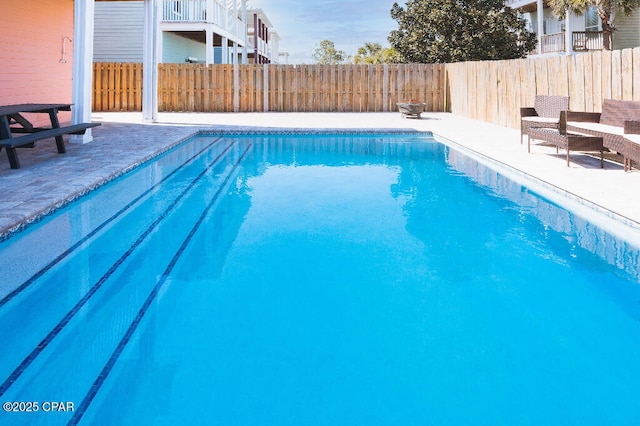 view of swimming pool with a patio area, a fenced in pool, and a fenced backyard