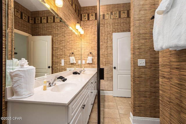 full bath featuring tile patterned floors, double vanity, and a sink