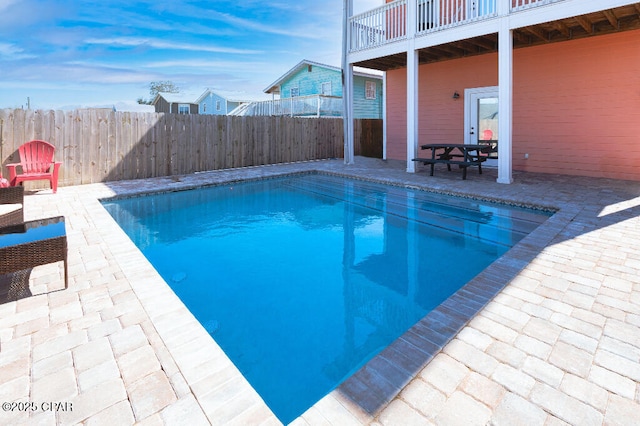 view of pool featuring a fenced in pool, a fenced backyard, and a patio area