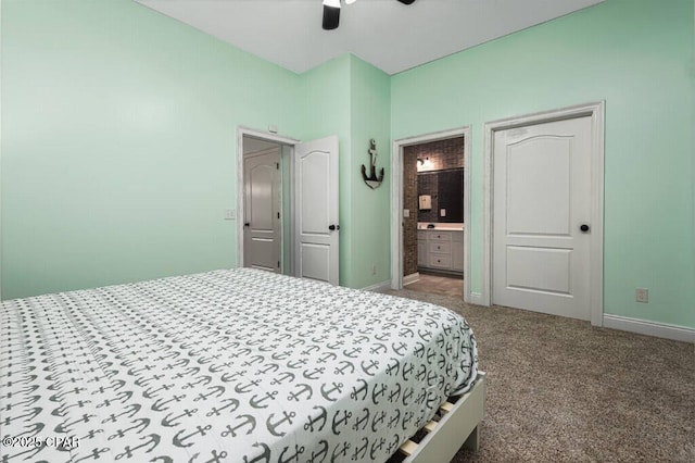 carpeted bedroom featuring ceiling fan, baseboards, and ensuite bath