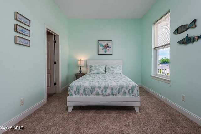 bedroom with carpet flooring and baseboards