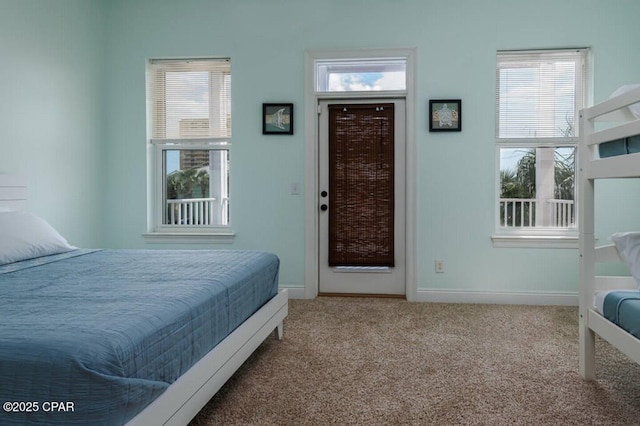 bedroom with multiple windows, baseboards, and carpet