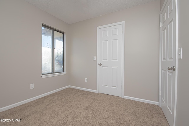 unfurnished bedroom with carpet floors and a textured ceiling