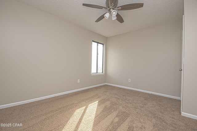 unfurnished room with ceiling fan, a textured ceiling, and carpet