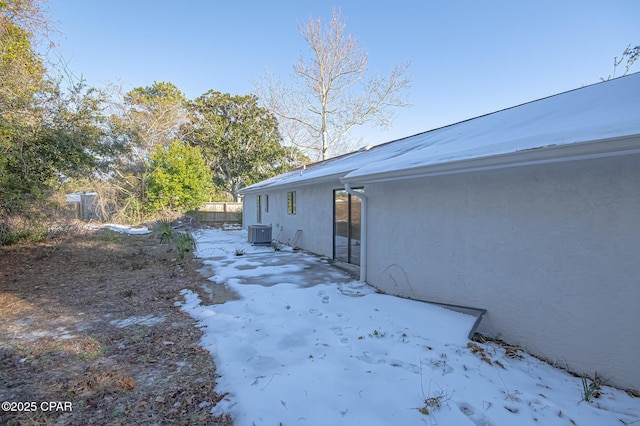 view of snowy exterior with central AC