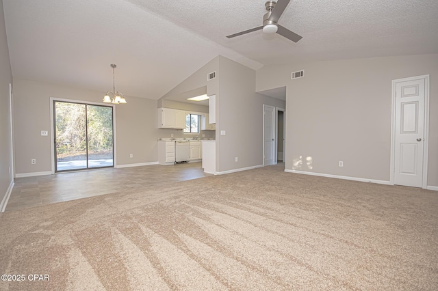 unfurnished living room featuring vaulted ceiling, ceiling fan with notable chandelier, light colored carpet, and a textured ceiling