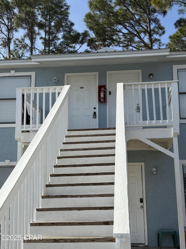 view of exterior entry featuring a balcony