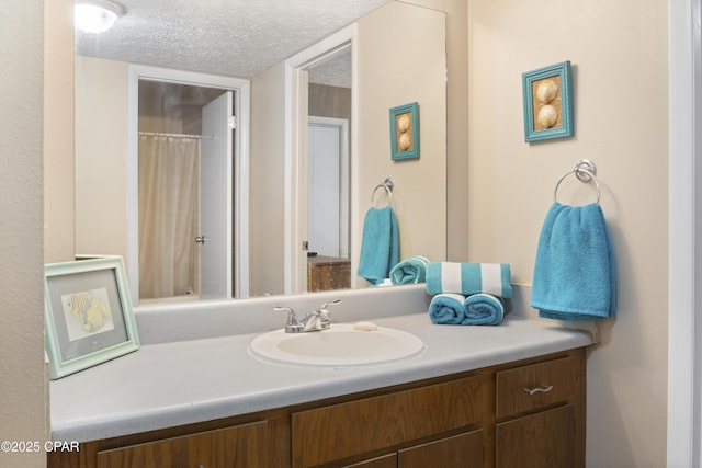 bathroom with vanity and a textured ceiling