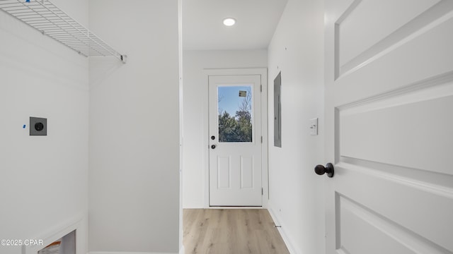 laundry area featuring hookup for an electric dryer and light hardwood / wood-style floors