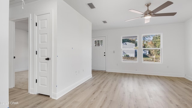 empty room featuring light hardwood / wood-style flooring and ceiling fan