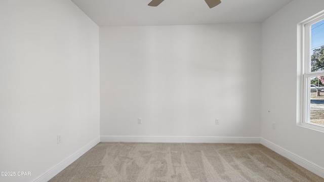 carpeted empty room with ceiling fan