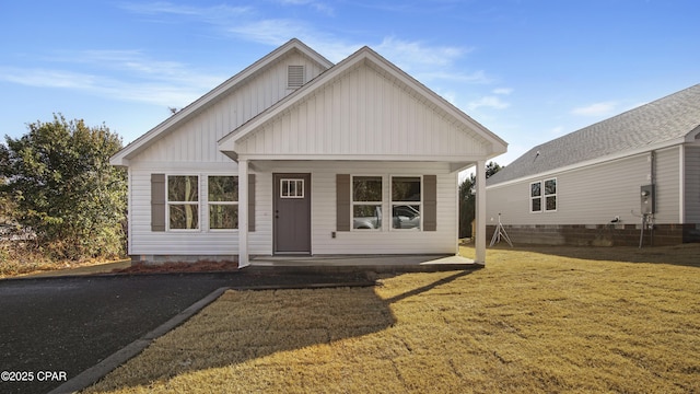 view of front of property with a front yard and a porch