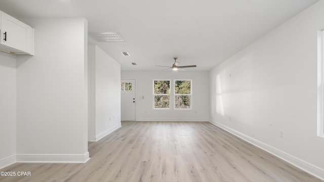 spare room with ceiling fan and light wood-type flooring