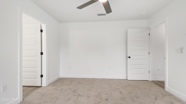 empty room featuring light colored carpet and ceiling fan