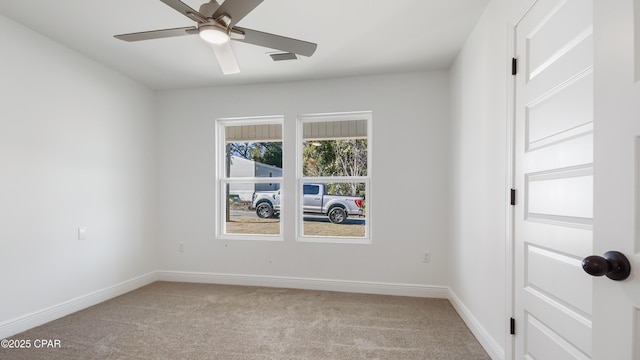 carpeted spare room featuring ceiling fan