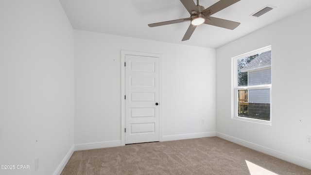 carpeted empty room featuring ceiling fan