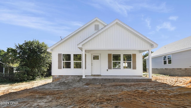 back of house featuring covered porch