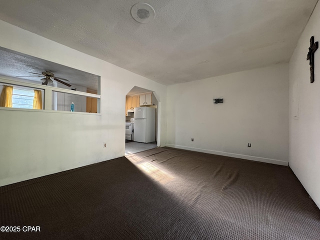 3109 Union Hill Rd, Marianna, FL 32446 - unfurnished living room with a textured ceiling, carpet, arched walkways, and a ceiling fan