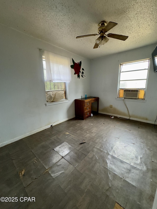 empty room featuring ceiling fan, cooling unit, and a textured ceiling