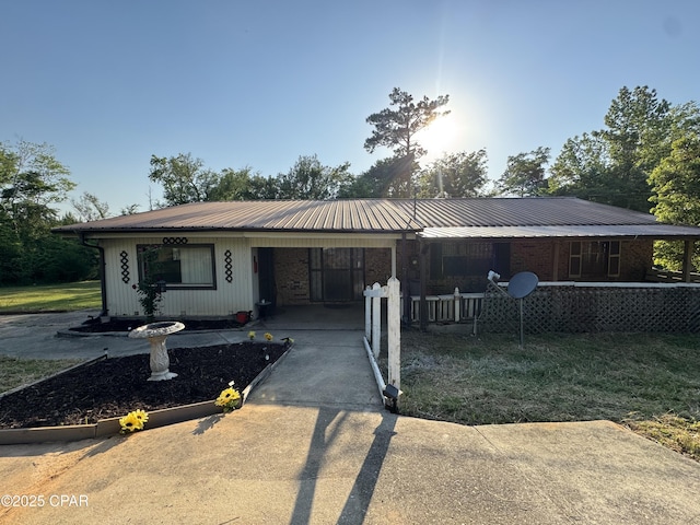 3109 Union Hill Rd, Marianna, FL 32446 - ranch-style house with covered porch, concrete driveway, metal roof, and an attached carport