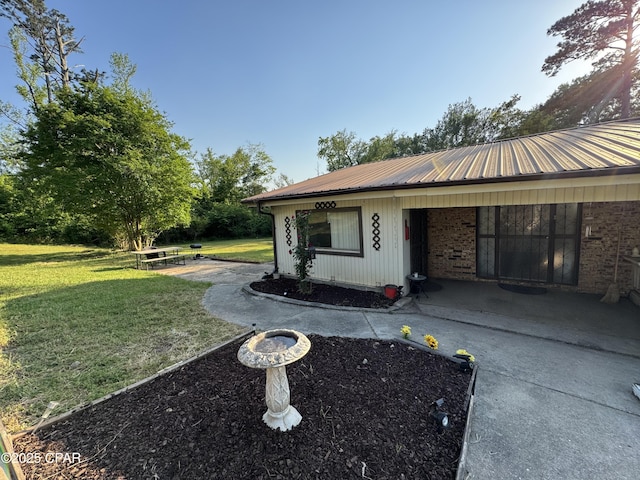 3109 Union Hill Rd, Marianna, FL 32446 - exterior space with a patio, metal roof, and a lawn