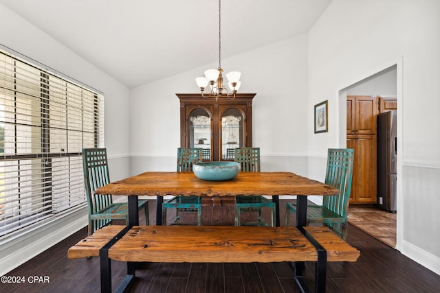 dining area featuring an inviting chandelier, vaulted ceiling, dark hardwood / wood-style floors, and plenty of natural light