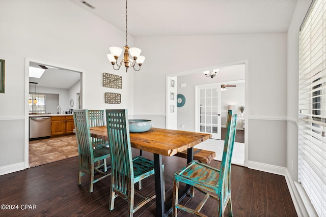 dining area featuring lofted ceiling, hardwood / wood-style floors, and a notable chandelier