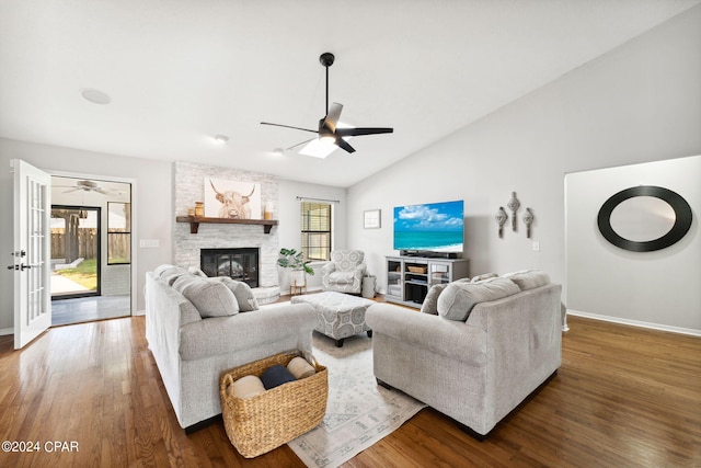 living room with a fireplace, dark hardwood / wood-style floors, ceiling fan, and vaulted ceiling