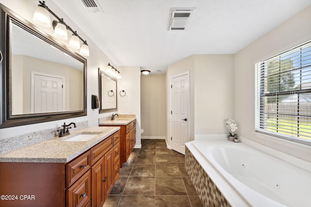 bathroom featuring a relaxing tiled tub, tile patterned floors, vanity, and toilet