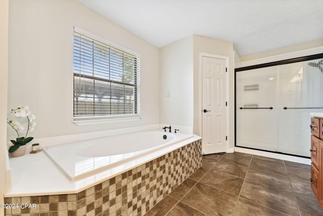 bathroom featuring vanity, tile patterned floors, and shower with separate bathtub