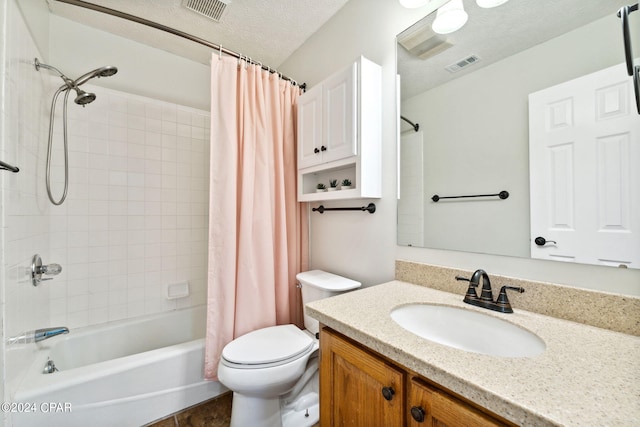 full bathroom with vanity, toilet, a textured ceiling, and shower / bath combo with shower curtain