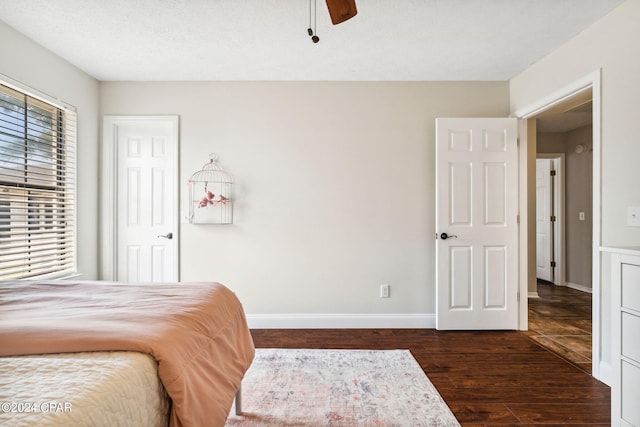 bedroom with dark wood-type flooring and ceiling fan