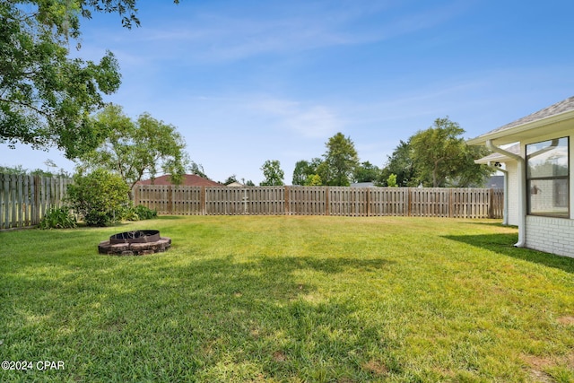 view of yard with a fire pit