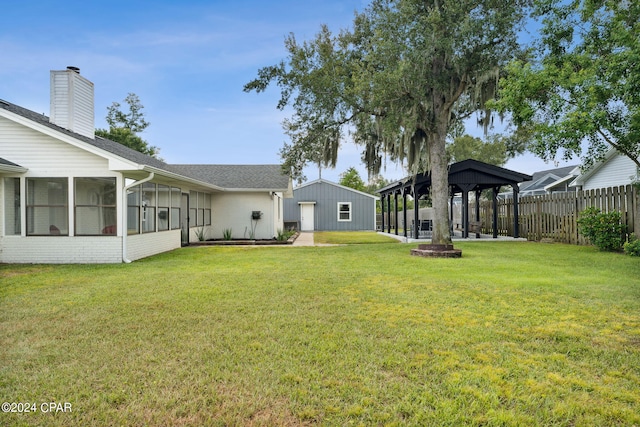 view of yard featuring a gazebo and a sunroom