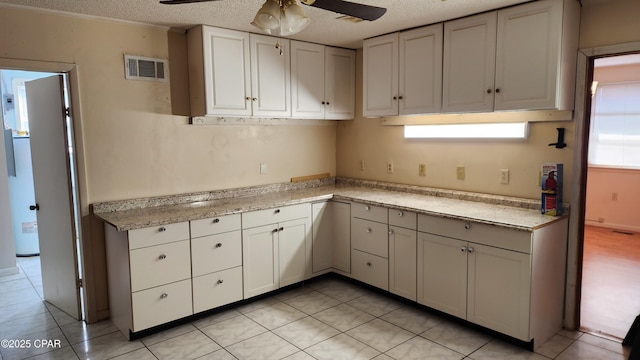 kitchen featuring light tile patterned floors, a wealth of natural light, and ceiling fan