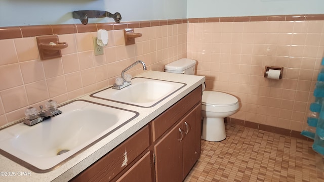 bathroom featuring tile walls, vanity, tile patterned floors, and toilet