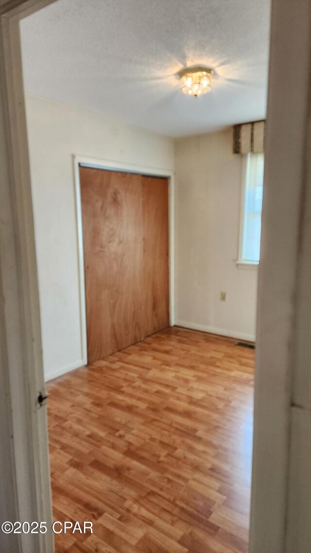 unfurnished room with light hardwood / wood-style floors