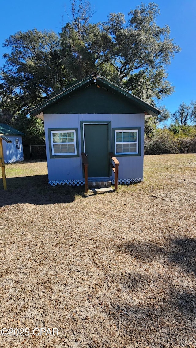 view of front facade with a storage unit