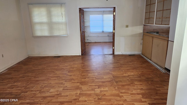 unfurnished dining area featuring light wood-type flooring