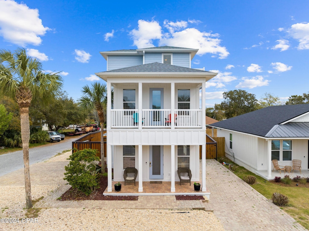 view of front of home featuring a balcony and covered porch