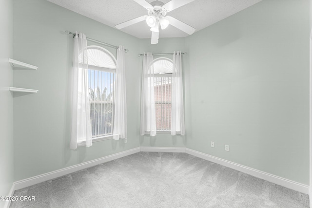 spare room with carpet flooring, a textured ceiling, and ceiling fan