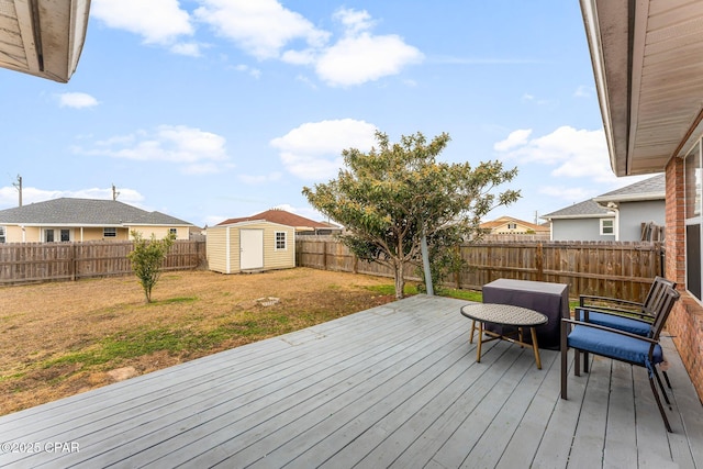 wooden deck with a shed and a yard