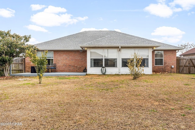 back of house featuring a patio and a lawn