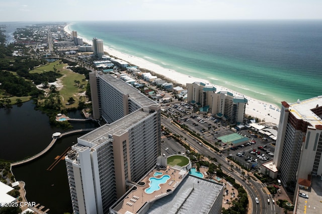 drone / aerial view with a water view and a beach view