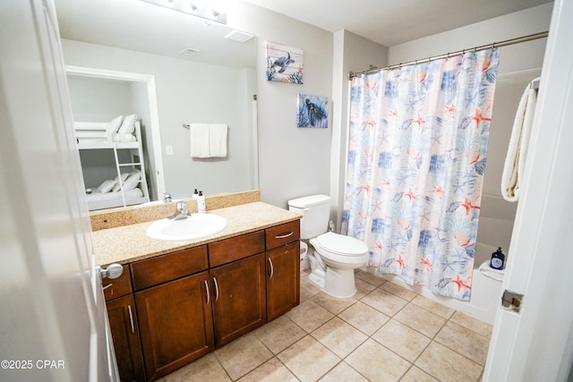 bathroom with vanity, toilet, and tile patterned flooring