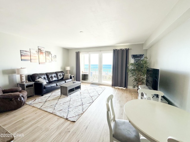 living room featuring a water view and hardwood / wood-style floors