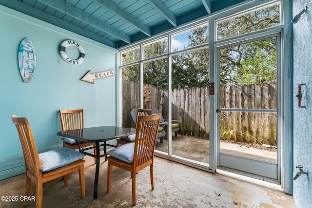 sunroom / solarium featuring beam ceiling and wooden ceiling