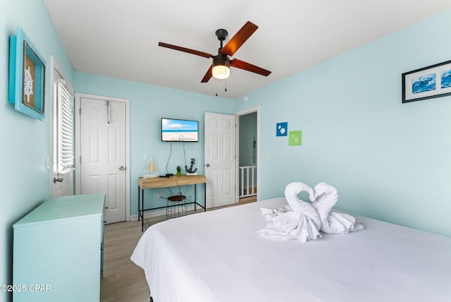 bedroom featuring light hardwood / wood-style floors, a closet, and ceiling fan