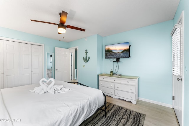 bedroom with light hardwood / wood-style flooring, a closet, and ceiling fan