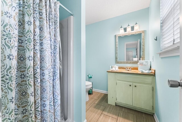 17214 Front Beach Rd Unit T28, Panama City Beach, FL 32413 - bathroom featuring toilet, wood tiled floors, vanity, a shower with curtain, and baseboards